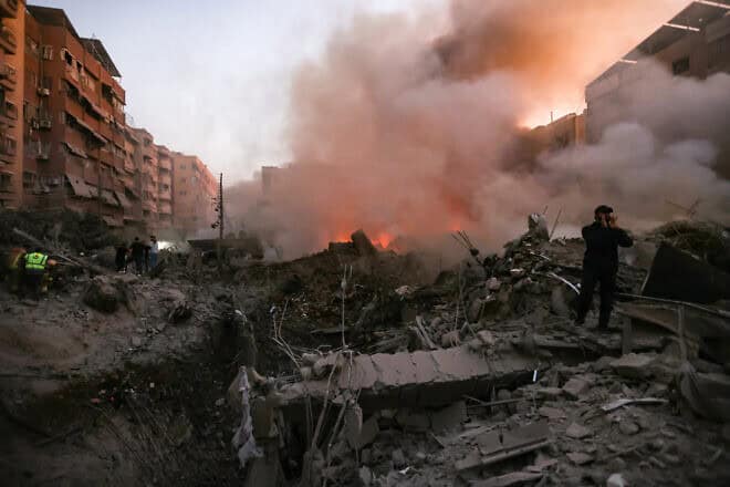 Bystanders and rescuers gather near the rubble of a building destroyed in an Israeli airstrike in the Haret Hreik neighborhood of Beirut's southern suburbs on Sept. 27, 2024. Photo by Ibrahim Amro/AFP via Getty Images.