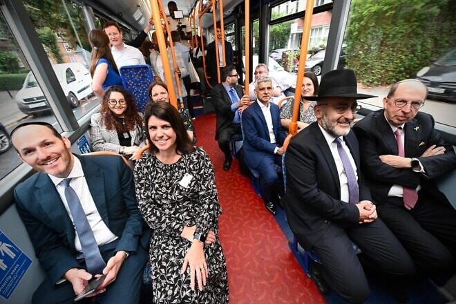 A 310 bus line, launched in September 2024 in London, connects Jewish communities in Golders Green and Stamford Hill. Sadiq Khan, the London mayor, is seated in the middle without a tie. Credit: London Jewish Forum.