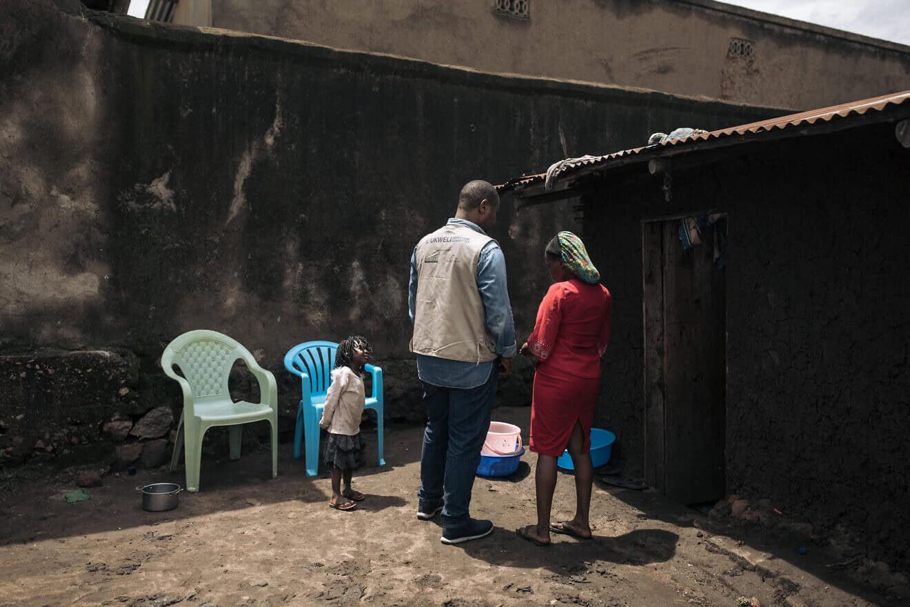 A Bridgeway Foundation team member talks to a woman in Kasindi, Beni Territory, North Kivu Province in the eastern Democratic Republic of Congo, who was kidnapped by the ADF (Allied Democratic Forces) but managed to escape and went to a deradicalization center, May 9, 2024. Photo by Alexis Huguet/AFP via Getty Images.
