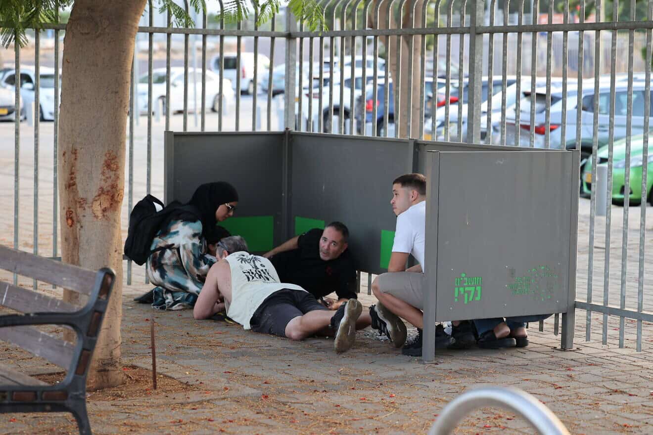 Israelis in Holon take cover as sirens warn of incoming missile fire from Lebanon, Oct. 14, 2024. Photo by Yossi Aloni/Flash90.