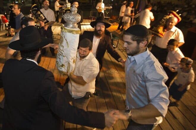 Jews dance with Torah scrolls during the Simchat Torah celebration in the Mediterranean coastal city of Netanya, north of Tel Aviv, on Oct. 8, 2012. Credit: Jack Guez/AFP/GettyImages.