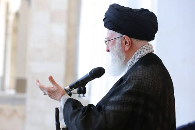 Iranian Supreme Leader Ayatollah Ali Khamenei stands with a rifle as he leads Friday prayer at the Imam Khomeini Musalla Mosque on Oct. 4, 2024 in Tehran, Iran. Photo by Iranian Leader's Press Office Handout/Getty Images.