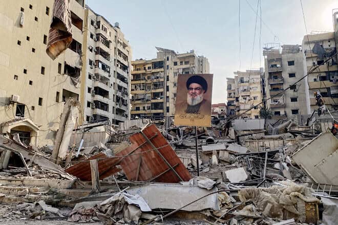 A portrait of slain Hezbollah leader Hassan Nasrallah sits amid debris in Beirut's southern suburbs following overnight Israeli airstrikes on Oct. 10, 2024. Photo by AFP via Getty Images.