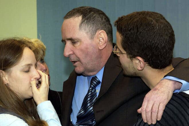 In this handout from the Israeli Government Press Office, Israeli businessman Elhanan Tannenbaum, who was held prisoner by the Lebanese Hezbollah since 2000, is surrounded by members of his immediate family after his arrival at Ben-Gurion International Airport after being released on Jan. 29, 2004. Photo by Avi Ohayon/GPO via Getty Images.