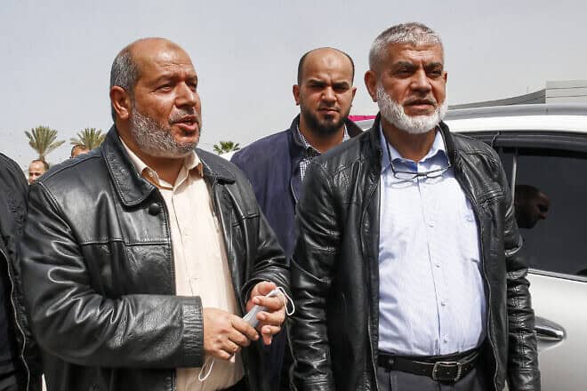 Senior Hamas members Khalil al-Hayya (left) and Rawhi Mushtaha stand outside the VIP hall at the Rafah border crossing with Egypt in the southern Gaza Strip on March 15, 2021. Photo by Said Kkatib/AFP via Getty Images.