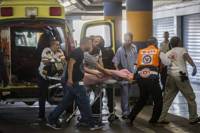 Medics take a 13-year-old girl, seriously wounded by a terrorist in Kiryat Arba in Judea, to the emergency room at Shaare Zedek Medical Center in Jerusalem on June 30, 2016. Photo by Yonatan Sindel/Flash90.