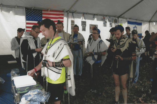Runners at the New York City Marathon participate in the marathon minyan before start time. Credit: Courtesy of the International Minyan.
