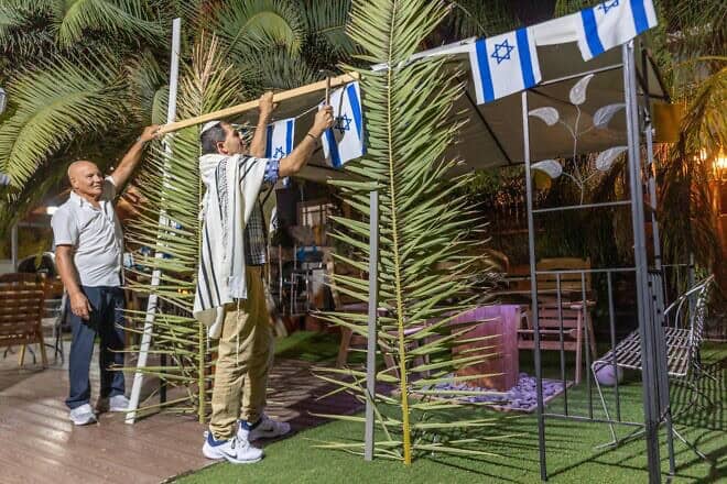 Israelis build and decorate a sukkah in moshav Yashresh in central Israel at the end of Yom Kippur for the upcoming Jewish holiday of Sukkot, Sept. 25, 2023. Photo by Yossi Aloni/Flash90.