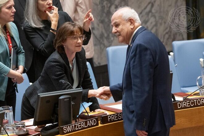 Pascale Christine Baeriswyl (left), the Swiss envoy to the United Nations and U.N. Security Council president for October, greets Riyad Mansour, the Palestinian "permanent observer" to the global body, ahead of the Security Council meeting on the situation in the Middle East on Oct. 9, 2024. Credit: Eskinder Debebe/U.N. Photo.