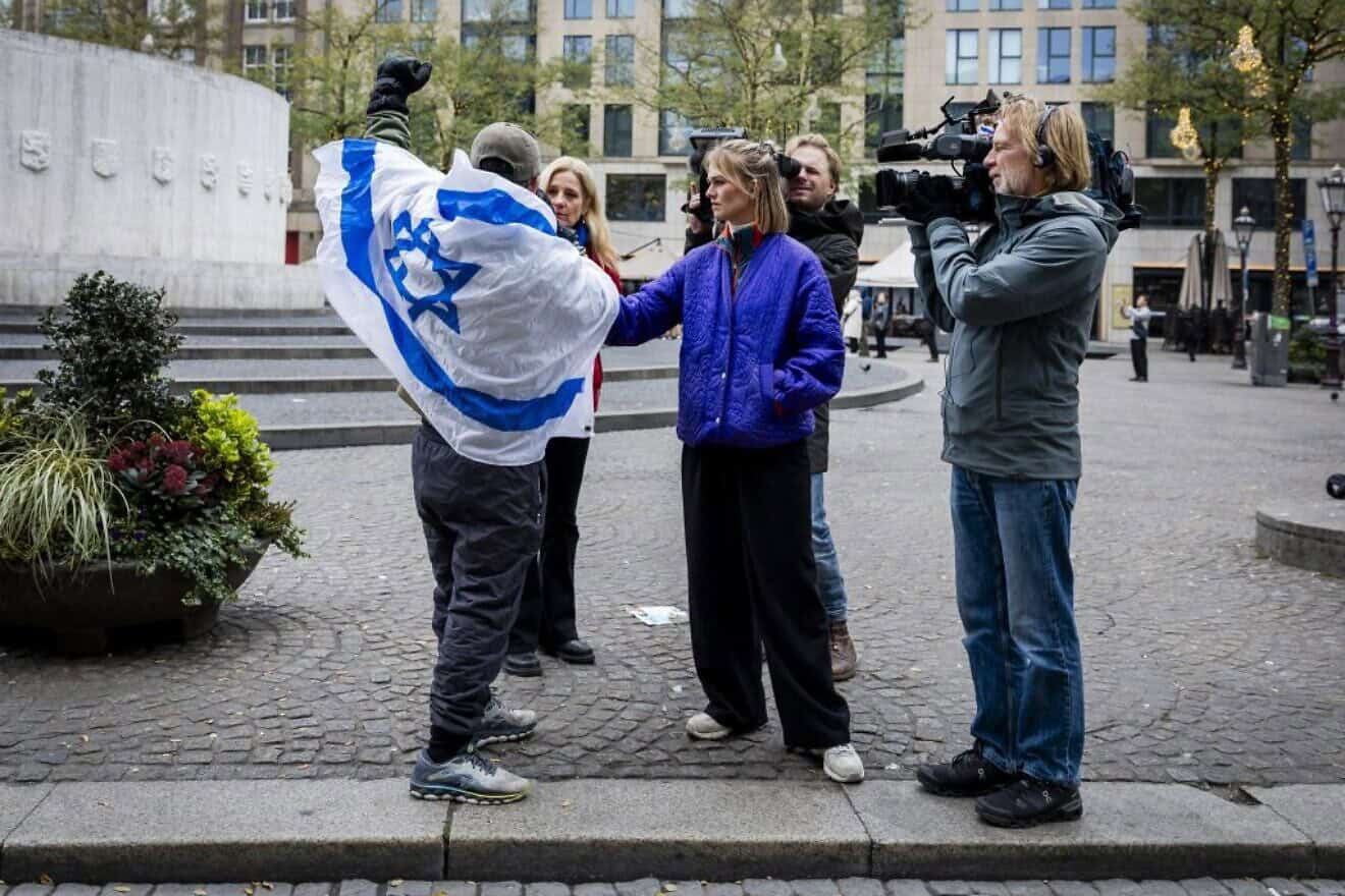 A man wearing an Israeli flag speaks with reporters in central Amsterdam on Nov. 8, 2024. Photo by Remko de Waal/ANP/AFP via Getty Images.