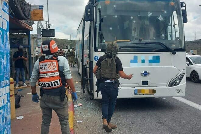 A United Hatzalah medic and an off-duty soldier examine a bus that was attacked near Ariel in Samaria on Nov. 29, 2024. Credit: United Hatzalah.