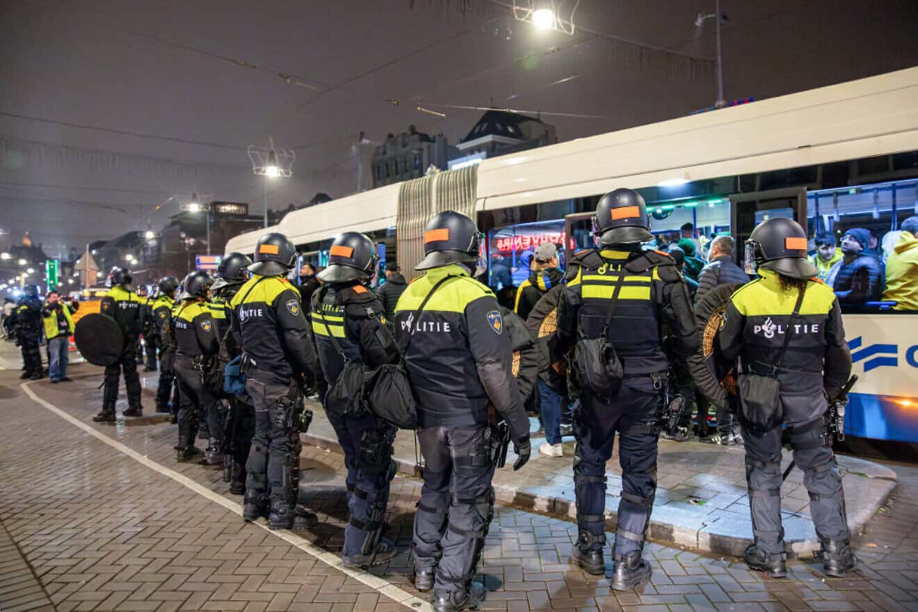 Dutch mobile police officers stand guard after violence broke out in central Amsterdam following the UEFA Europa League soccer match between Ajax Amsterdam and Maccabi Tel Aviv, Nov. 8, 2024. Photo by VLN Niews/ANP/AFP via Getty Images.