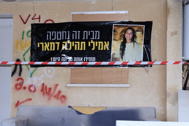 A large poster reading "Emily Tehila Damari was taken hostage from this house" is seen in Kibbutz Kfar Aza, Jan. 3, 2024. Photo by Moshe Shai/Flash90.
