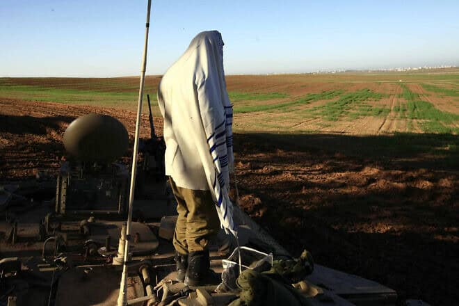 An infantry soldier prays after a long night of battling Hamas terrorist, Jan. 6, 2009. Photo by Nati Shohat/Flash90.