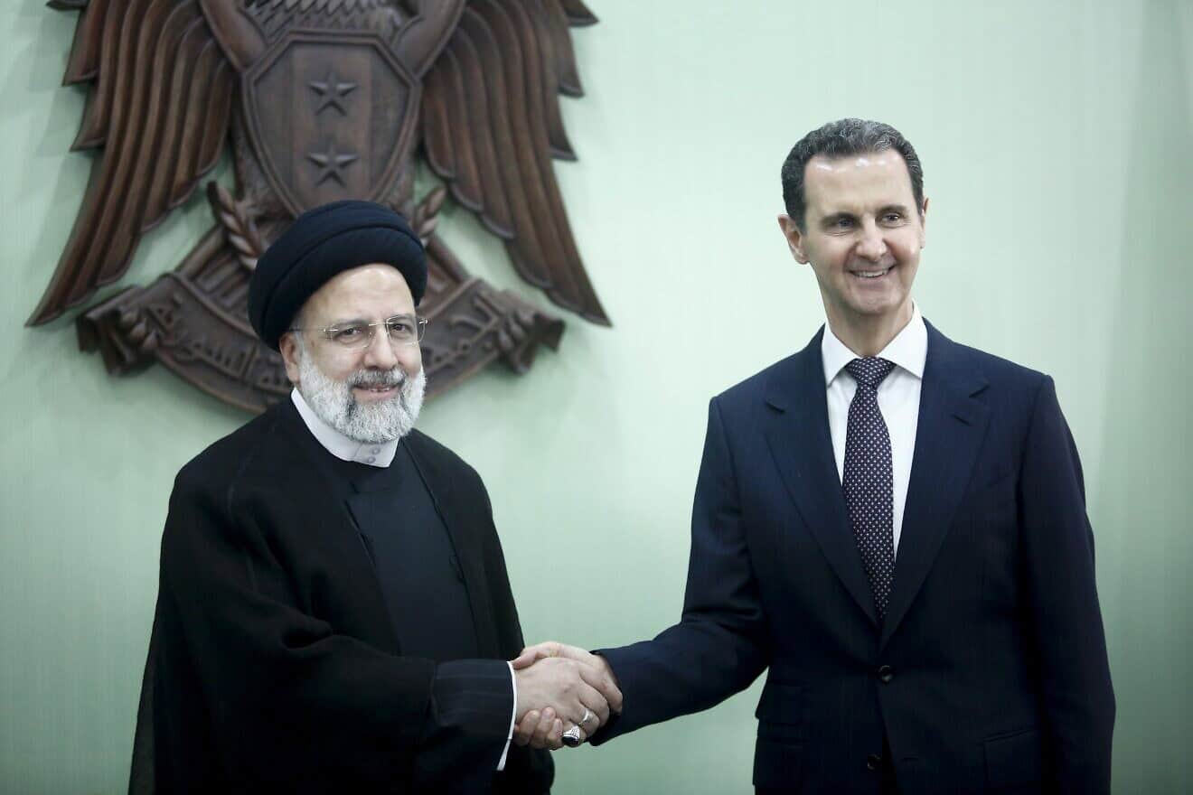 Syria's President Bashar al-Assad, (R) and Iranian counterpart Ebrahim Raisi exchange documents after signing a memoranda of understanding on "long-term strategic cooperation" in Damascus, Syria, May 3, 2023. Photo by Borna News/Matin Ghasemi/Aksonline ATPImages/Getty Images.