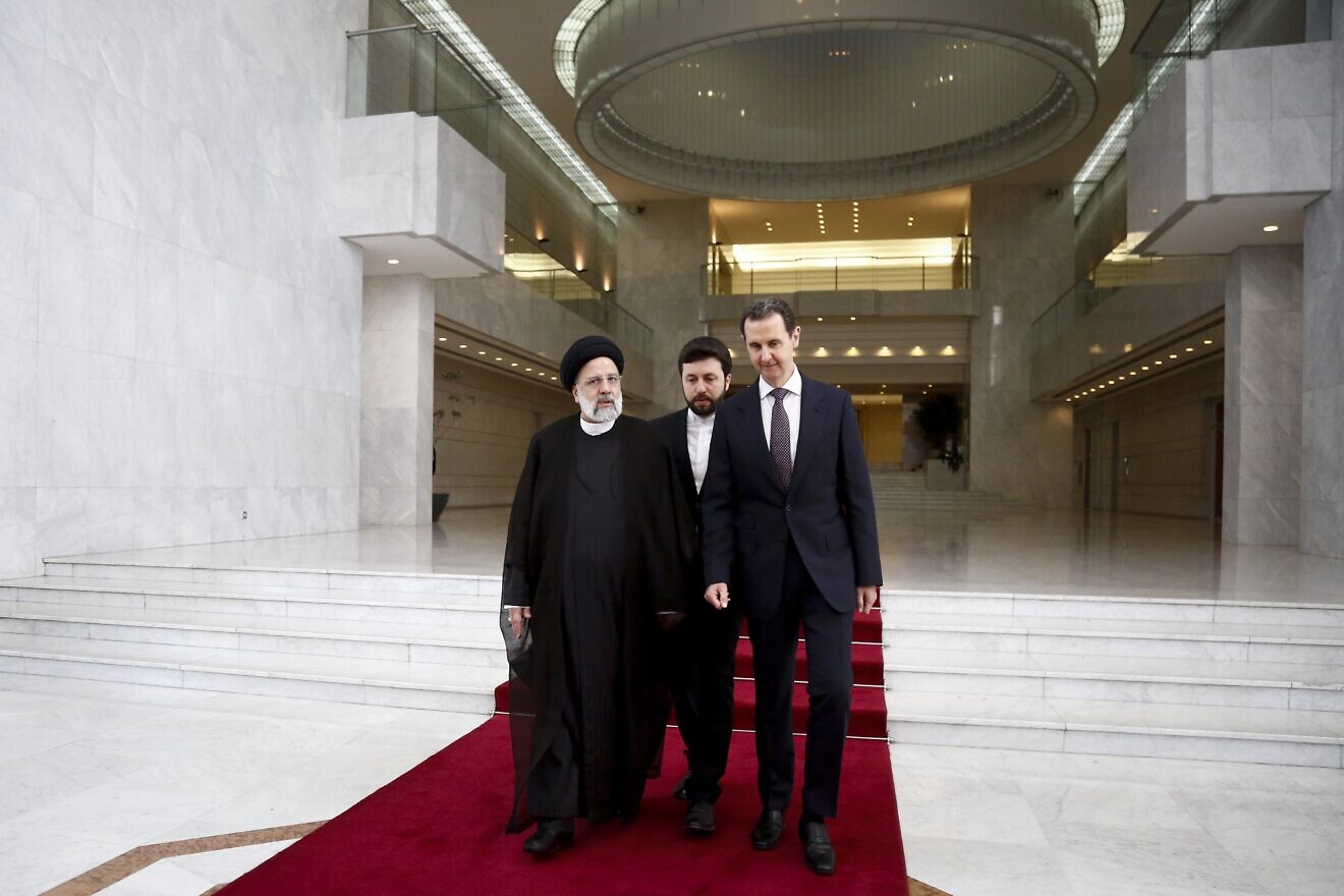 Syrian President Bashar Assad (right) and his Iranian counterpart, the late Ebrahim Raisin (left), exchange documents after signing a memorandum of understanding on "long-term strategic cooperation" in Damascus, Syria, on May 3, 2023. Photo by Borna News/Matin Ghasemi/Aksonline ATPImages via Getty Images.