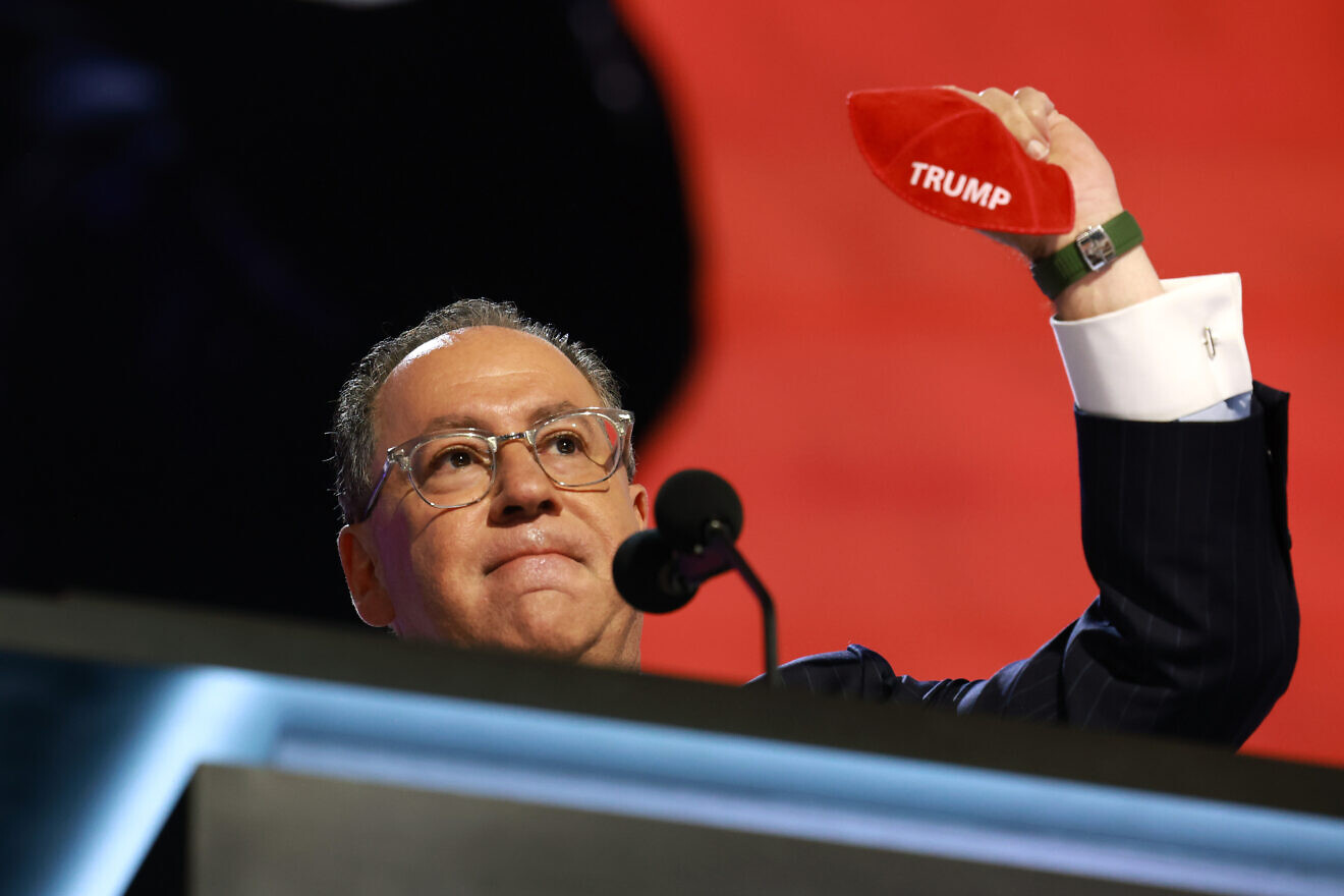 Matt Brooks, CEO of Republican Jewish Coalition, holds up a kippah with the name "Trump" on stage on the second day of the Republican National Convention at the Fiserv Forum on July 16, 2024 in Milwaukee, Wisc. Photo by Joe Raedle/Getty Images.