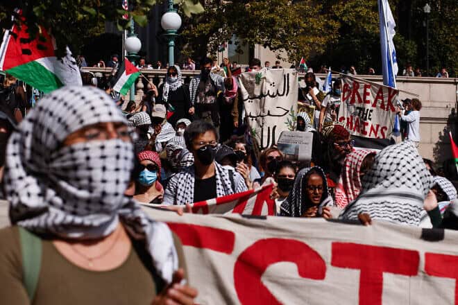 Pro-Palestinian demonstrators march through the Columbia University campus in New York City to mark one year of the war between Hamas and Israel, on Oct. 7, 2024. Photo by Kena Betancur/AFP via Getty Images.