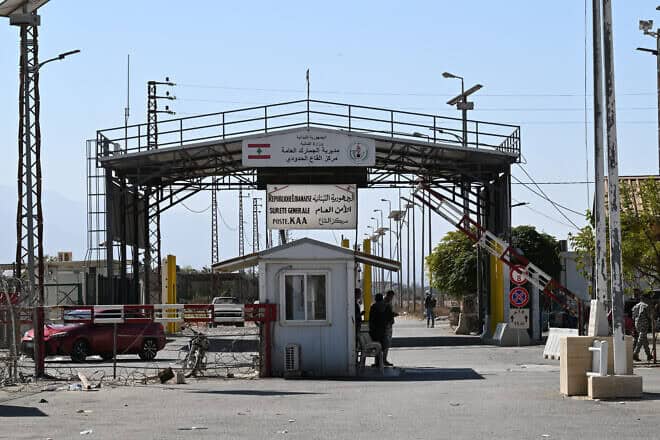 Lebanese government officials stand on Lebanon's Qaa side of Syria's Jousieh border crossing on Oct. 28, 2024. Photo by Louai Beshara/AFP via Getty Images.