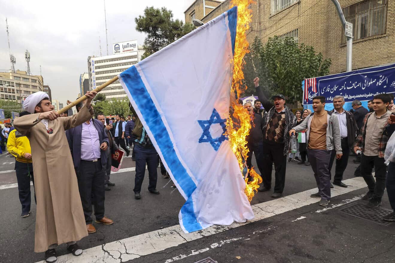 People burn an Israeli flag during a rally outside the former U.S. embassy in Tehran as Iranians mark the 45th anniversary of the start of the Iran hostage crisis, on Nov. 3, 2024. Photo by Atta Kenare/AFP via Getty Images.
