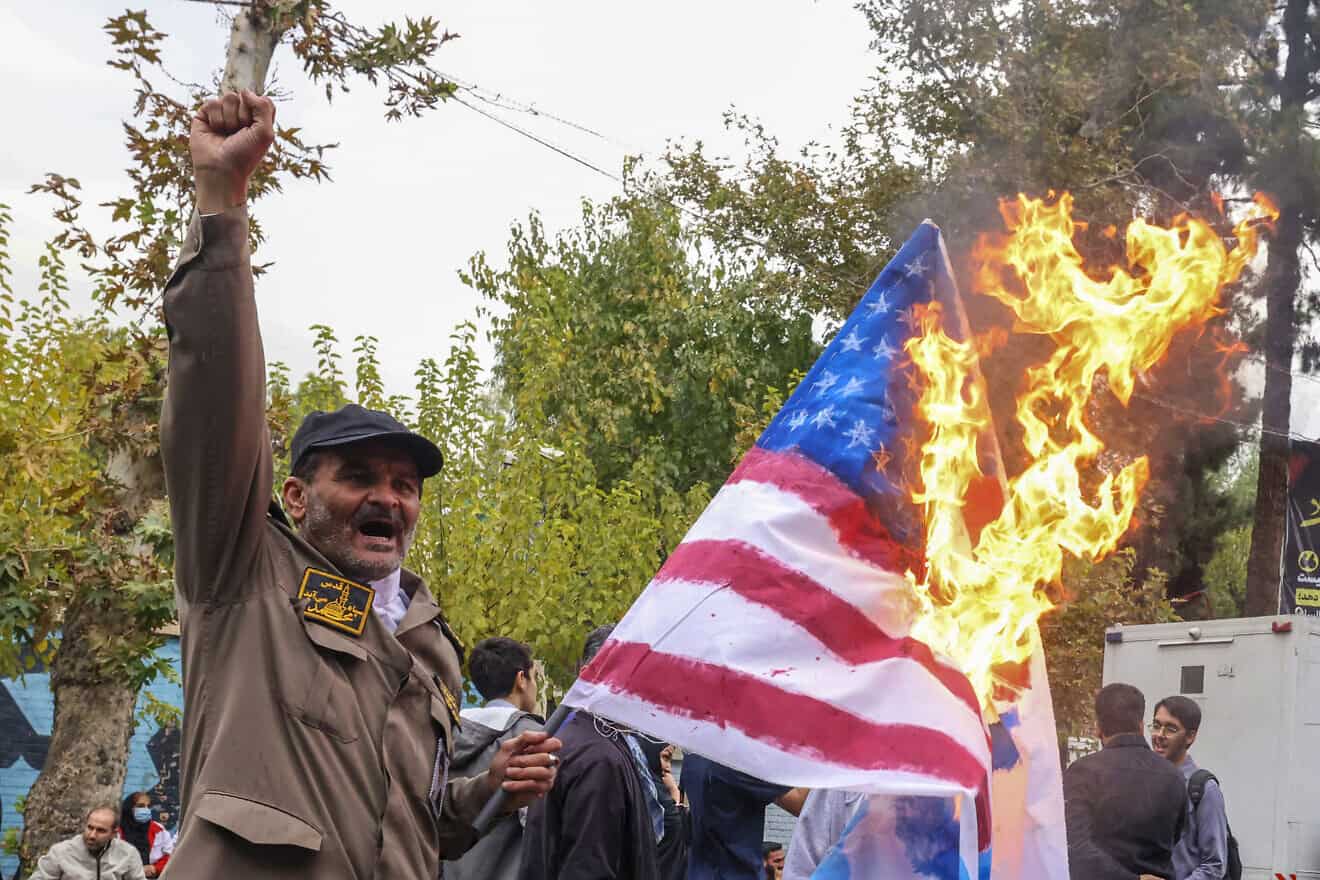 A man holds a burning American flag during a rally outside the former U.S. embassy in Tehran as Iranians mark the 45th anniversary of the start of the Iran hostage crisis, on Nov. 3, 2024. Photo by Atta Kenare/AFP via Getty Images.
