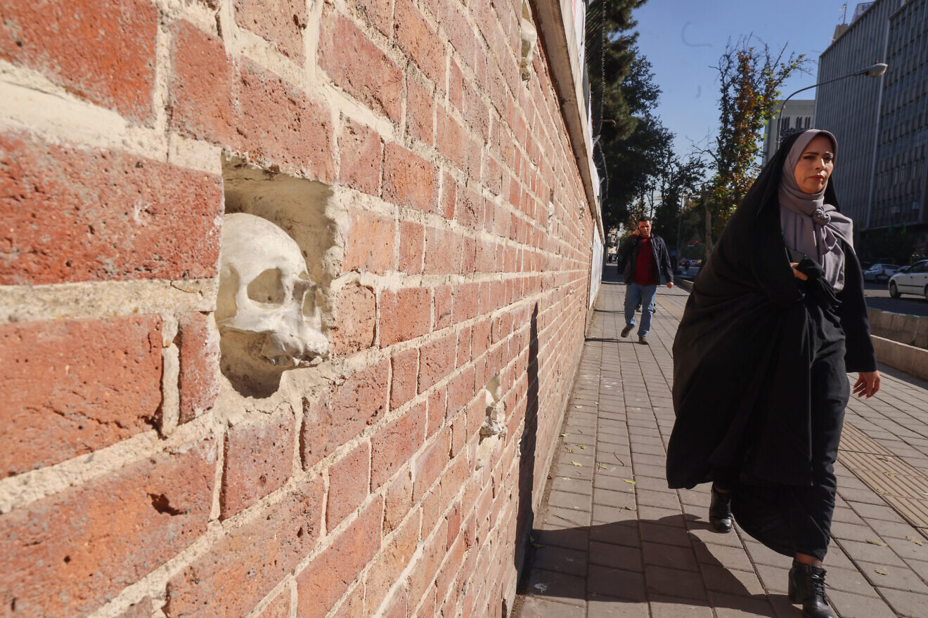 A woman walks past the wall of the former U.S. embassy in Tehran on Nov. 6, 2024. Photo by Atta Kenare/AFP via Getty Images.