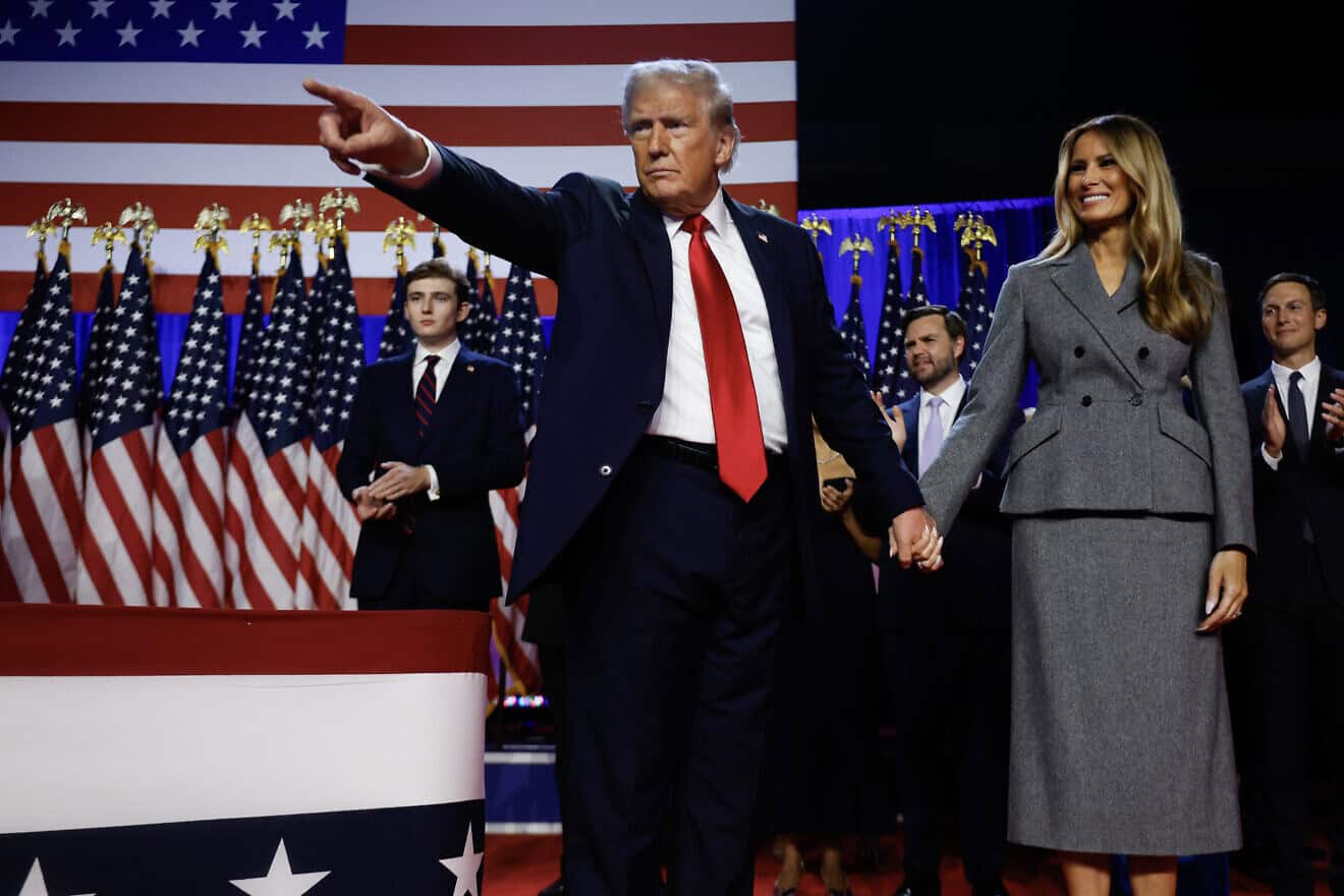 Republican presidential nominee, former U.S. President Donald Trump points to supporters with former first lady Melania Trump during an election night event at the Palm Beach Convention Center on Nov. 6, 2024 in West Palm Beach, Florida. Photo by Chip Somodevilla/Getty Images.