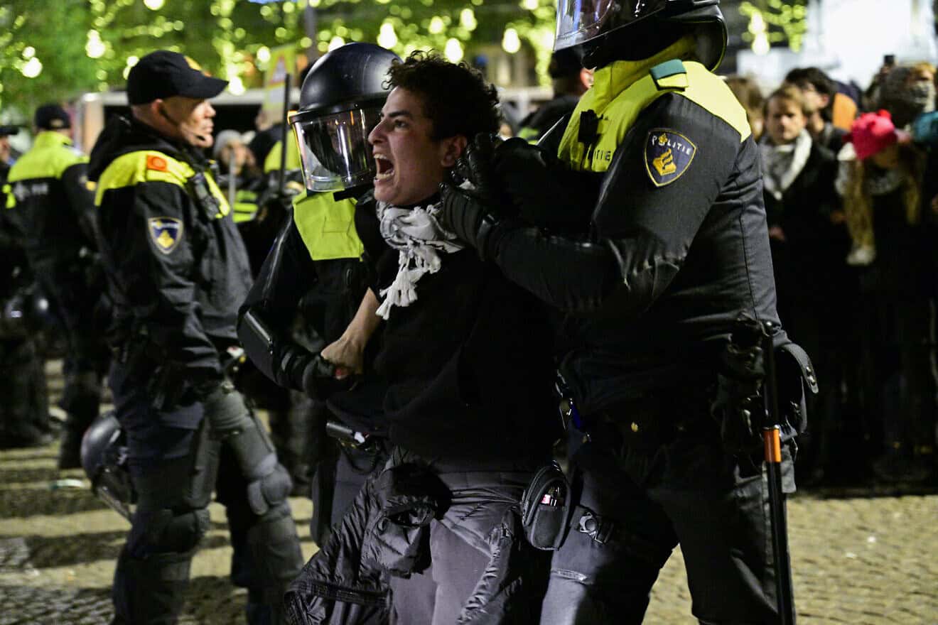 Police officers detain a protestor during an unauthorized pro-Palestinian demonstration on Dam Square in Amsterdam on Nov. 13, 2024. Photo by Nick Gammon/AFP via Getty Images.