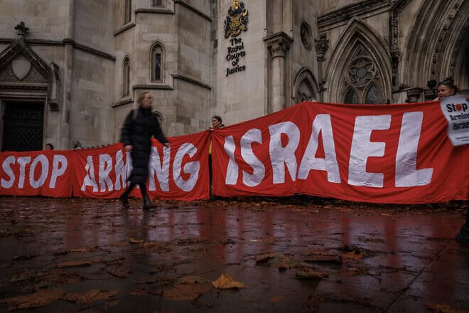 Campaigners from Amnesty International UK and Human Rights Watch hold banners outside the Royal Court of Justice in London, Nov. 18, 2024. Photo by Dan Kitwood via Getty Images.