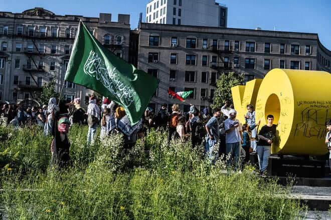 Pro-Palestinian and pro-Hamas demonstrators associated with the Within Our Lifetime anti-Israel, antisemitic group, scrawl graffiti on an outdoor statue at the Brooklyn Museum in New York City on May 31, 2024. Photo by Stephanie Keith/Getty Images.