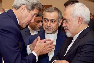 U.S. Secretary of State John Kerry speaks with Hossein Fereydoun (center), the brother of Iranian President Hassan Rouhani, and Iranian Foreign Minister Javad Zarif, before they addressed an international press corps gathered at the Austria Center in Vienna after the European Union, United States, and the rest of its P5+1 partners reached agreement on a plan to prevent Iran from obtaining a nuclear weapon in exchange for sanctions relief, July 14, 2015. Credit: U.S. State Department Photo/Public Domain.
