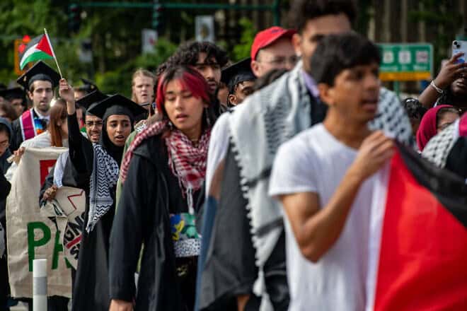 Anti-Israel students march over the Massachusetts Avenue Bridge after walking out during the OneMIT Commencement Ceremony at the Massachusetts Institute of Technology in Cambridge, Massachusetts, on May 30, 2024. Photo by Joseph Prezioso/AFP via Getty Images.