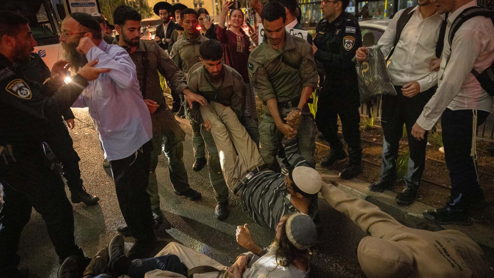 Police clash with Zionist activists, including Baruch Marzel (left), during a protest at the western entrance to Jerusalem against the administrative detention of Judea and Samaria activists, May 2, 2024. Photo by Chaim Goldberg/Flash90.