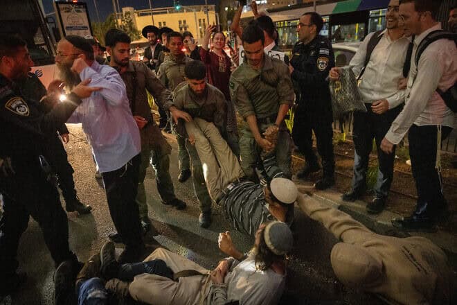 Police clash with Zionist activists, including Baruch Marzel (left), during a protest at the western entrance to Jerusalem against the administrative detention of Judea and Samaria activists, May 2, 2024. Photo by Chaim Goldberg/Flash90.