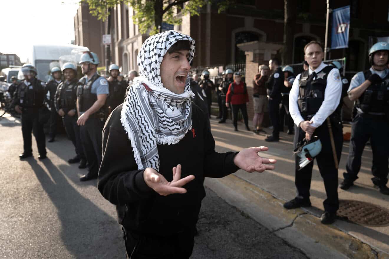 Chicago police guard an entrance to campus while workers remove a pro-Palestinian encampment at DePaul University, in the Lincoln Park neighborhood of the city, on May 16, 2024. Photo by Scott Olson/Getty Images.