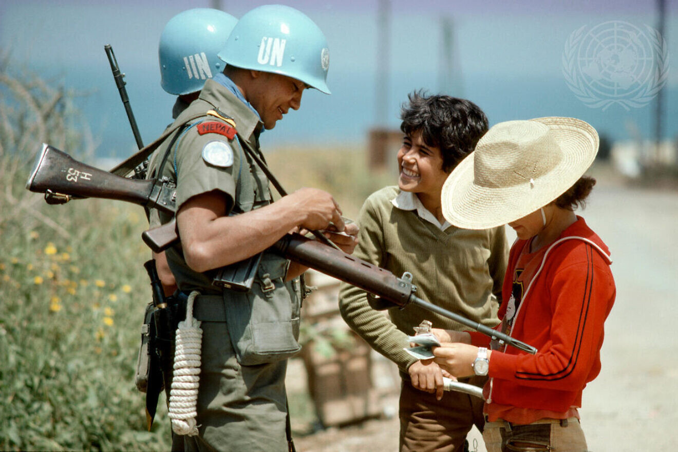 Nepalese soldiers serving with UNIFIL chatting with two young Lebanese boys outside UNIFIL headquarters in Naqoura, April 27, 1978. Credit: John Isaac/U.N. Photo.