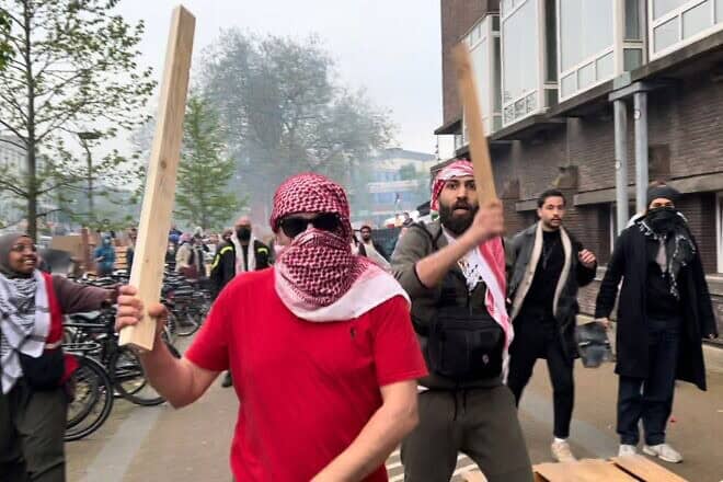 Anti-Israel rioters close in on a Jewish man at the University of Amsterdam on May 6, 2024. Credit: Courtesy.