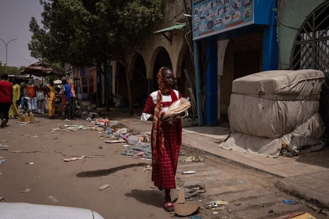 A woman dresses up for the Muslim holiday of Eid al-Fitr, marking the end of the fasting month of Ramadan, carries bread in N'Djamena, Chad, on April 10, 2024. Photo by Ed Ram/Getty Images.