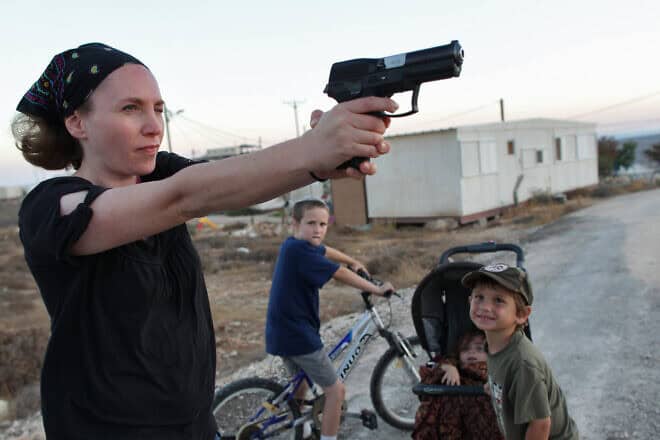 A woman practices aiming her weapon at Pnei Kedem in Gush Etzion, Judea, on Sept. 21, 2011. Photo by Nati Shohat/Flash90.