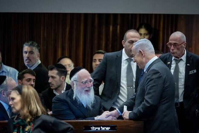 Israeli Prime Minister Benjamin Netanyahu speaks with MK Yisrael Eichler at the  Knesset, the Israeli parliament in Jerusalem, Feb. 19, 2024. Photo by Yonatan Sindel/Flash90