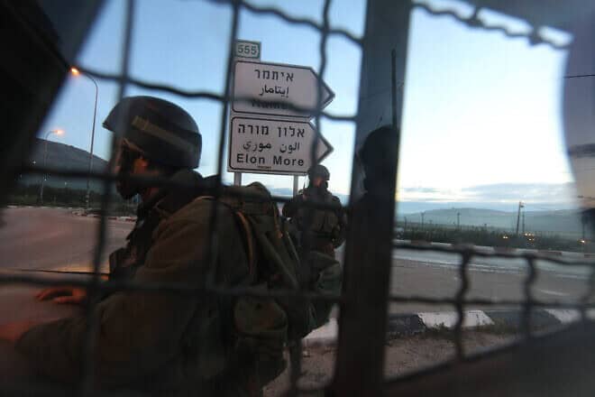 Israeli soldiers block a road near Huwara, south of the Samaria city of Nablus (Shechem), March 12, 2011. Photo by Nati Shohat/Flash90.
