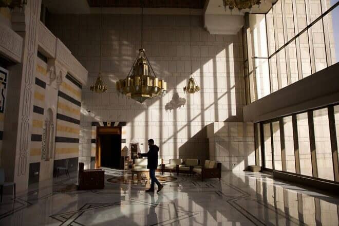A man films on his phone inside the Presidential Palace on Mount Mezzeh, west of Damascus, on Dec. 10, 2024. Photo by Ali Haj Suleiman/Getty Images.