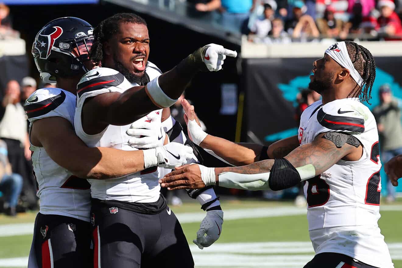 Azeez Al-Shaair, No. 0 of the Houston Texans, points to the Jacksonville Jaguars bench after a fight and being ejected during the second quarter of a game at EverBank Stadium  in Jacksonville, Fla., on Dec. 1, 2024. Photo by Mike Carlson/Getty Images.