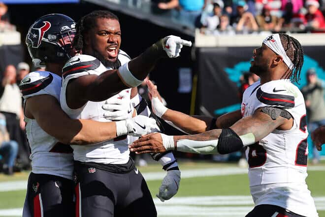 Azeez Al-Shaair, No. 0 of the Houston Texans, points to the Jacksonville Jaguars bench after a fight and being ejected during the second quarter of a game at EverBank Stadium  in Jacksonville, Fla., on Dec. 1, 2024. Photo by Mike Carlson/Getty Images.
