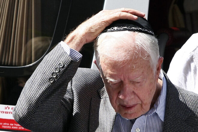 Former U.S. President Jimmy Carter puts on a yarmulke before meeting with the religious leader of the Jewish Sephardic community, Rabbi Ovadia Yosef, in Jerusalem on Aug. 25, 2009. Credit: Abir Sultan/Flash90.