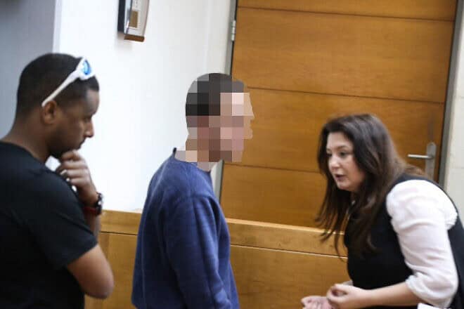 A man brought for a court hearing at the Rishon Lezion Magistrate's Court, under suspicion of Issuing fake bomb threats against Jewish institutions around the world, on March 23, 2017. Photo by Flash90.