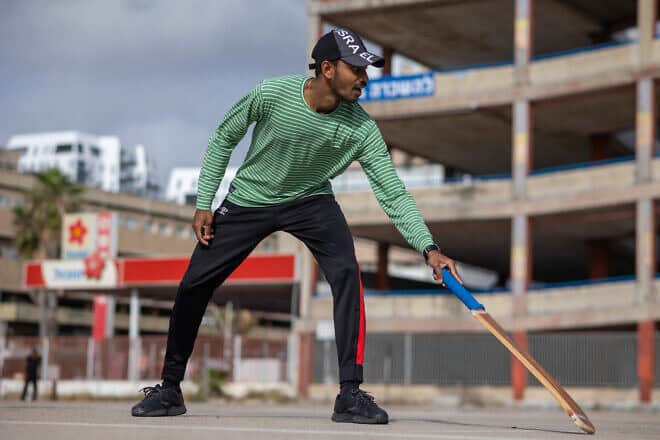 A foreign workers from India plays cricket on an empty parking lot in south Tel Aviv, April 27, 2024. Photo by Dor Pazuelo/Flash90.