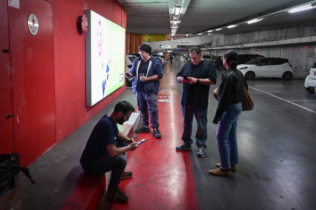 Israelis take cover inside a bomb shelter as siren alerts are sounded in Tel Aviv, Dec. 16, 2024. Photo by Avshalom Sassonif/Flash90.