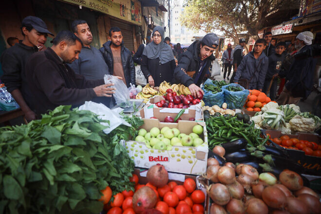 Palestinians shop at the Deir al-Balah market in Gaza, Dec. 19,2024. Photo by Ali Hassan/Flash90.