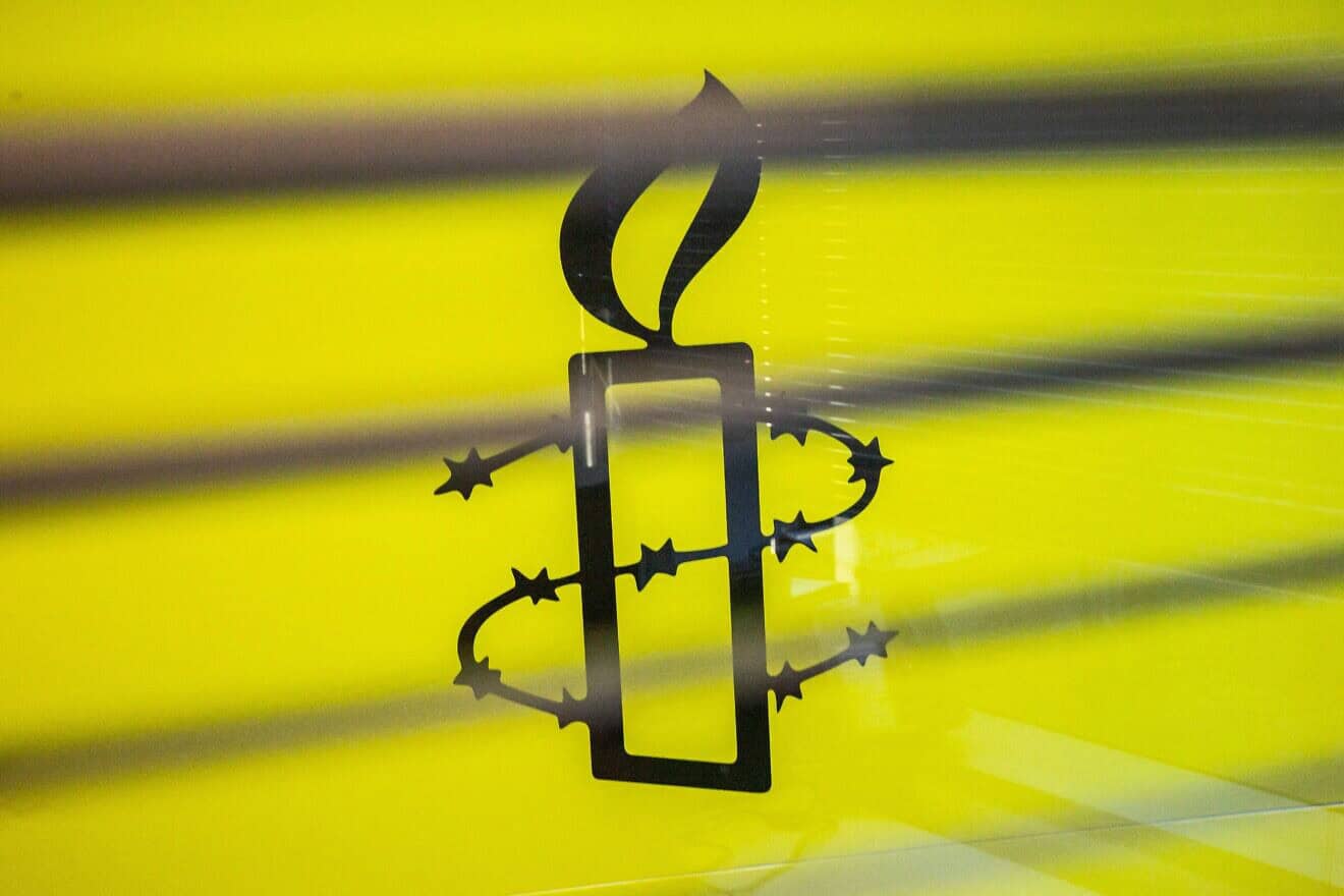 The Amnesty International logo is seen in their offices in Hong Kong, October 2021. Photo by Isaac Lawrence/AFP via Getty Images.